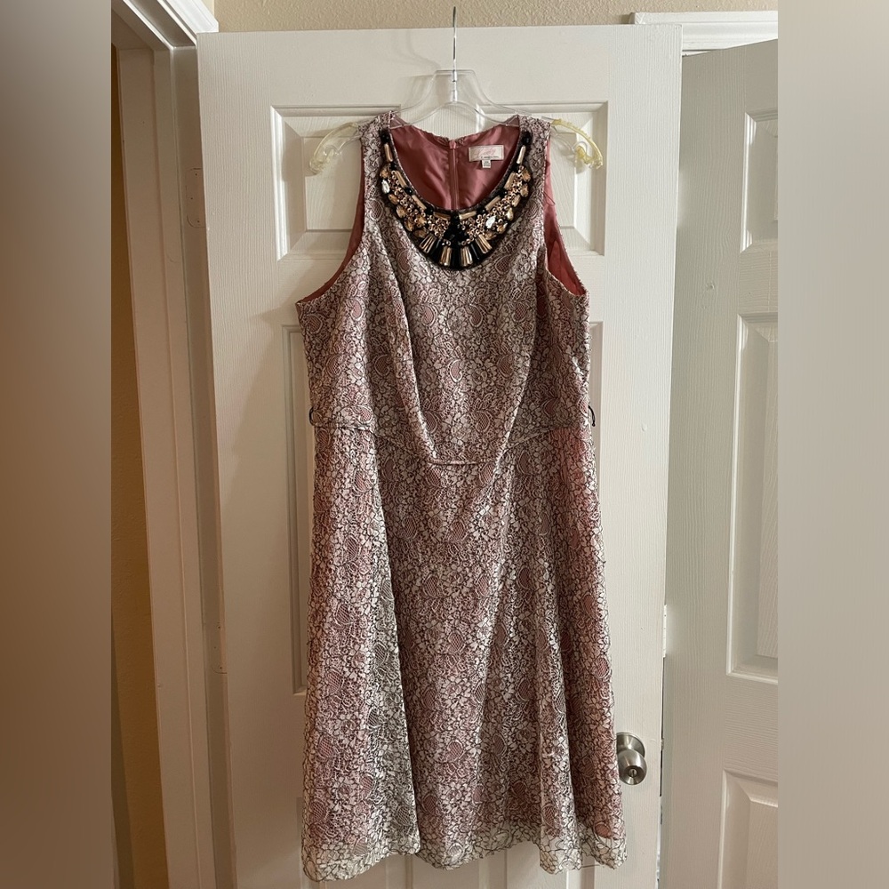 Lace dress with beaded collar.